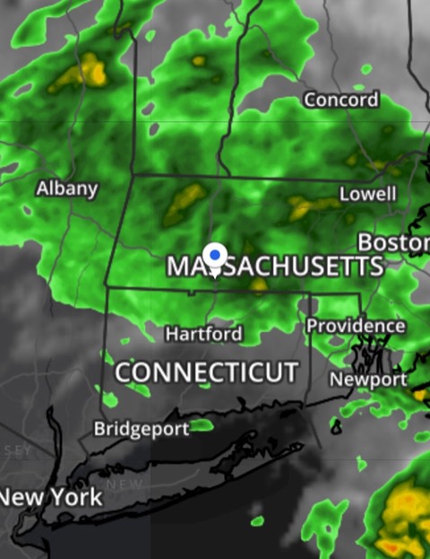 The interactive weather map for a person's location — a dark map with a location pin and a storm cell moving in over nearby towns.